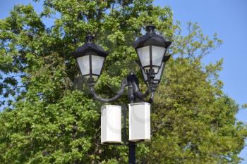 The loudspeaker on the pole. Outdoor speakers for fun walking in the park. A pillar with lights and speakers