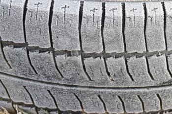 Hoarfrost on a rubber tire wheel. Morning frost.