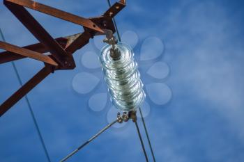 Glass prefabricated high voltage insulators on poles high-voltage power lines. Electrical industry.