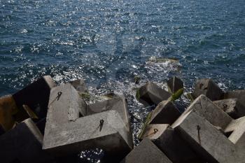 Breakwater blocks in the port. Breakwater of the rectangular stone figures.