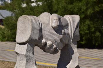 Sculpture handshake. Symbol of friendship and cooperation.