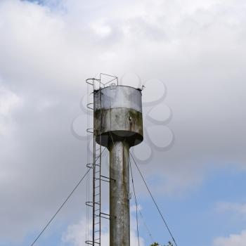 Stork on a roof of a water tower. Stork nest.