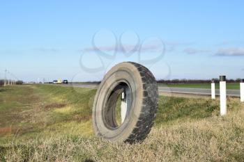 RUSSIA, TRUDOBELIKI - DECEMBER 23, 2015. Rubber tire of a wheel at the intersection. A wheel at the road.