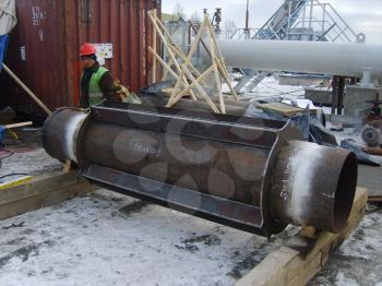 Sakhalin, Russia - 12 November 2014: Welding of a dyuker in a cartridge. Strengthening of a design of the pipeline.