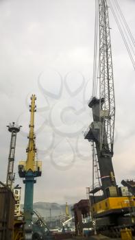 Novorossiysk, Russia - August 11, 2016: Port cranes against the sky. Cargo industrial port