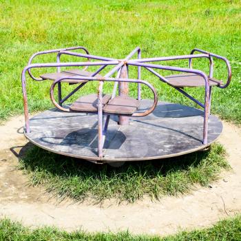 Children's iron carousel. Children's playground. Swing, carousel and slide.