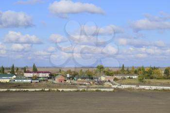 A view from above of a small Russian village. Rural landscape. Field and village. A semi-abandoned village