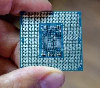 The processor is a desktop computer in hand. Inspect the CPU contacts before installing.