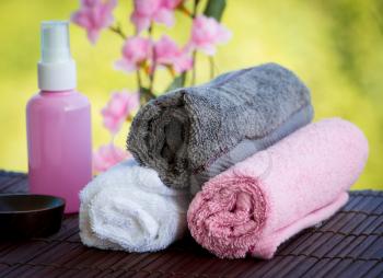 Body Care Therapy Objects Including Towels Oil and Flowers