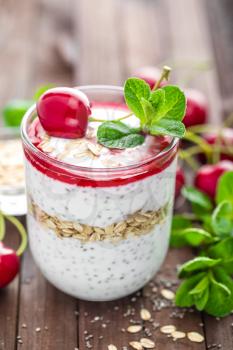 Fresh cherry yogurt with oats and chia seeds, healthy breakfast