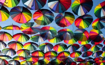 Multi-colored umbrellas in the sky.Umbrellas rainbow colors