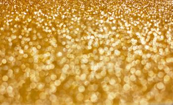 Gold bokeh holiday textured glitter background.defocused abstract gold christmas background