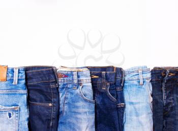 Jeans blue in a row on a white background. texture of denim