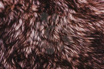 Brown dark warm faux fur texture. Animal wildlife concept