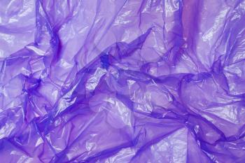 Purple plastic bag. The concept of using environmentally friendly packaging, processing and sorting, preservation of the environment