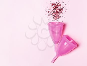 Pink menstrual cup . Concept of women's health, hygienic means of protection, menstruation, ecology of the planet.