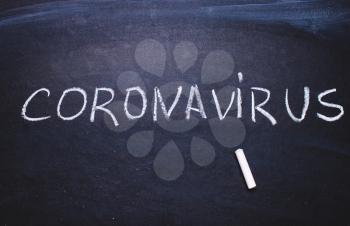 Inscription coronavirus on chalk board. Epidemic concept