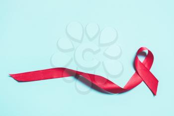 Pink, red ribbon on a blue background. The symbol of a worldwide campaign against breast cancer.