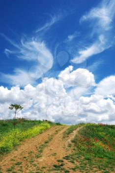 Road in village and beautiful clouds. Nature composition.