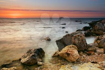 Sea and stone at the sunset. Nature composition.