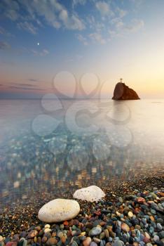 Sea and rock at the sunset. Nature composition. 