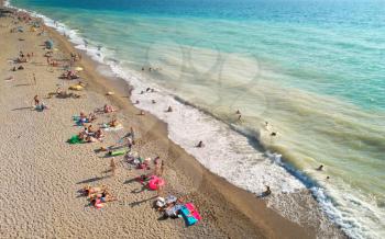 Aerial view at the beach. People relax on the sea shore. Beautiful natural seascape and summer time