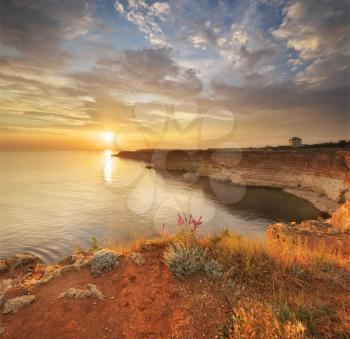 Sunset on cliffs. Beautiful summer nature and sea landscape. Relax composition.