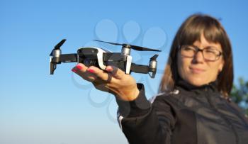 Drone landing on a woman hand palm. Element of design.