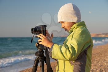 A young boy tries to learn and take photos.