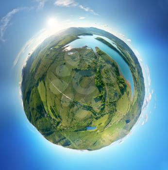 Little planet panorama of green mountain valley during sunset. Nature composition.