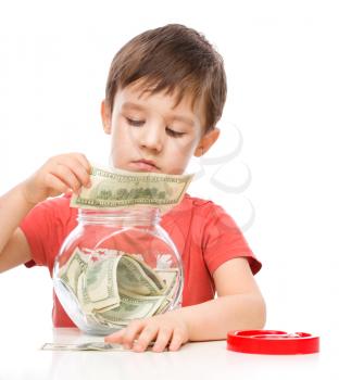 Cute boy with dollars, isolated over white