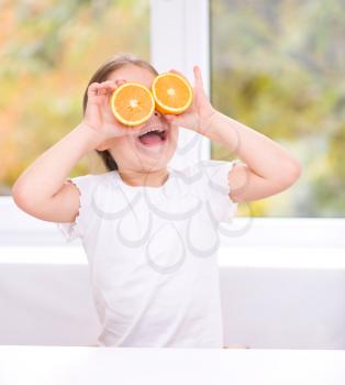 Happy girl with oranges