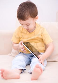 Happy little boy using tablet