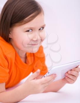 Happy little girl using tablet