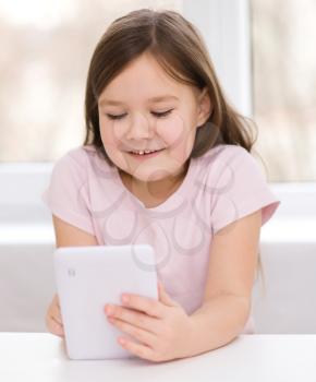 Happy little girl using tablet