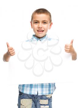 Happy boy is holding blank banner, isolated over white