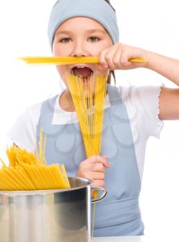 Pretty girl preparing spaghetti, isolated over white