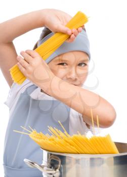 Pretty girl preparing spaghetti, isolated over white