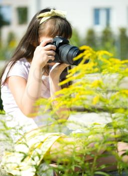 Beautiful girl photographing nature