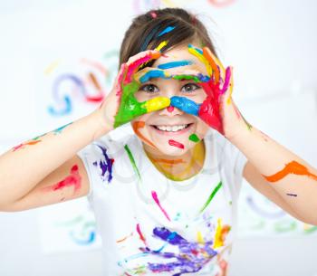 Cute girl showing her hands painted in bright colors