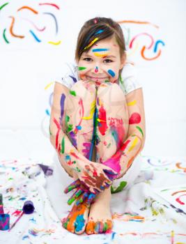Cute girl showing her hands painted in bright colors