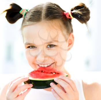 Cute girl is eating watermelon
