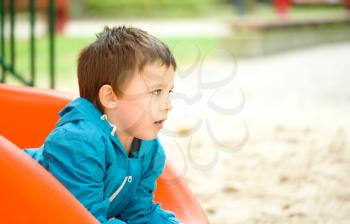 Cute little boy is playing on playground