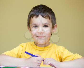 Little boy is holding bunch of color pencils