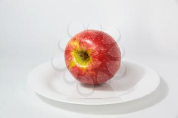 Large ripe red Apple with handle on white background