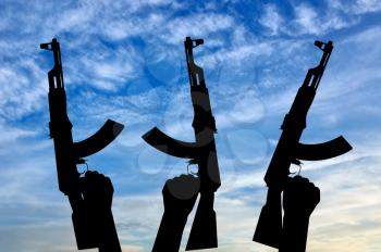 Terrorists concept. Weapons in the hands of terrorists, against the sky
