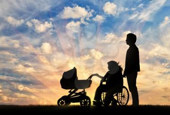 Disabled woman in wheelchair holding pram with her husband against sky. Concept disabled and family