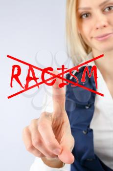 Racism and discrimination concept. A woman presses a finger on a word crossed out racism