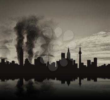Silhouette of the city in a smoke and reflection
