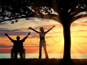 Concept of disability and disease. Silhouette happy disabled and guardian under a tree at sunset